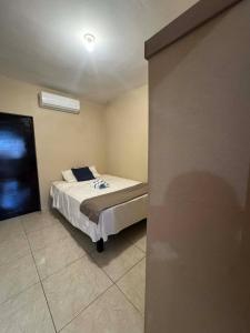 a small bedroom with a bed in the corner at Departamento #1 in San Carlos