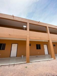 a building with four white garage doors on it at Departamento #1 in San Carlos +3 photos