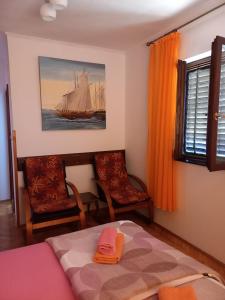 a bedroom with a bed and a sailboat on the wall at Apartment Maya in Banjole