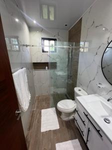 a bathroom with a shower and a toilet and a sink at Las margaritas in La Pascuala +44 photos