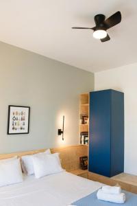 a bedroom with a bed with a blue cabinet at BaBu Urban Stay in Katerini