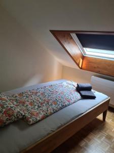 a bed with a quilt on it in a room at Ca' di Fant Malvaglia in Malvaglia