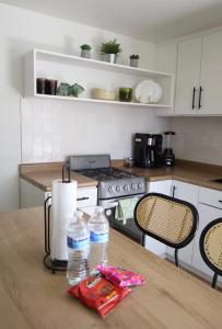 a kitchen with a table with two water bottles on it at Bello loft studio en el corazón de Tijuana in Tijuana
