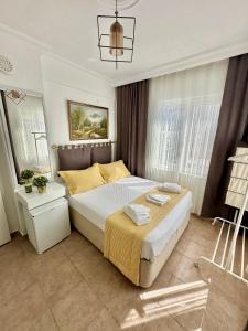 a bedroom with a large bed with yellow pillows at Hil Ada 1 in Bozcaada