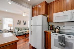 a kitchen with a white refrigerator and a living room at Turtle Nest Condo - Pool - 2nd Floor in Key West