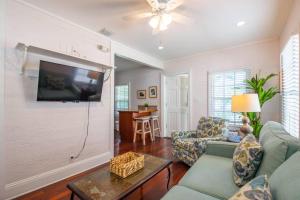 a living room with a couch and a tv at Turtle Nest Condo - Pool - 2nd Floor in Key West