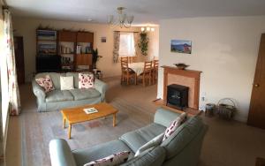 a living room with two couches and a fireplace at Cairn Shiel in Achnasheen