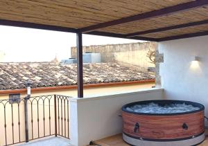 a hot tub on the balcony of a house at Casa Fioraliso in Noto