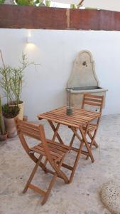 a wooden table and a chair next to a table at Casa Fioraliso in Noto