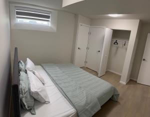 a bedroom with a large bed and a window at Dans luxury suite in Winnipeg