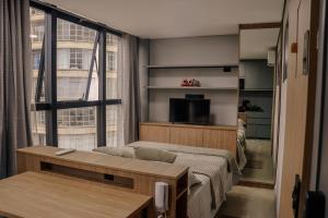 a small room with a bed and a window at TBG Studios in Curitiba +14 photos
