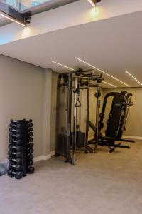 a gym with several tread machines in a room at TBG Studios in Curitiba
