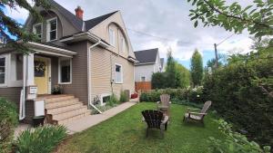 a yard with two chairs and a house at Charming Inner City Home in Calgary