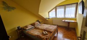 a small bedroom with a bed and a window at Oázis Apartman in Harkány +68 photos