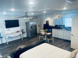 a kitchen with a bed and a table and a refrigerator at Serenity home in Laplace