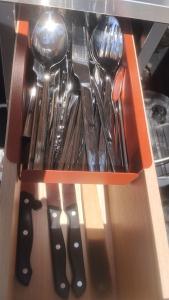 a drawer full of utensils in an orange box at Summer IGLOO by the sea in COCOland in Pálioura