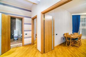 a room with a table and a dining room at 3 Bedrooms Apartment ın Center in Baku