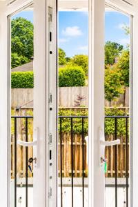 an open door with a view of a fence at Meadowvine - By Rowes Retreats in Penryn