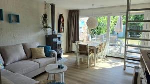 a living room with a couch and a table at Vakantiehuis Topaz in Bruinisse