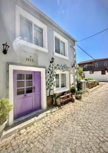 a house with a purple door on a street at Hil Ada 1 in Bozcaada