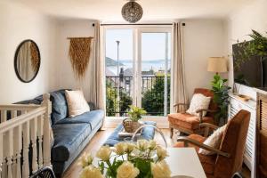a living room with a couch and a table at Tide View Townhouse - By Rowes Retreats in Falmouth