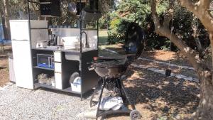 a barbecue grill sitting in front of a kitchen at Summer IGLOO by the sea in COCOland in Pálioura