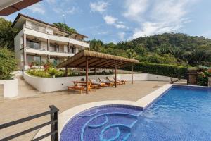a house with a swimming pool next to a building at Hotel Las Lomas in Nandayure +15 photos