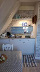 a kitchen with a sink and a counter top at Cosy Home in Scharbeutz