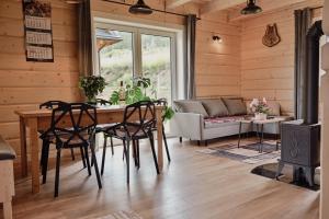 a living room with a table and chairs and a couch at Zdrojowe wzgórze in Rymanów-Zdrój