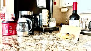 a kitchen counter with a blender and a bottle of wine at Boardwalk Oceanfront Condo with Panoramic Views in Virginia Beach