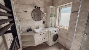 a bathroom with a washing machine and a sink at Zdrojowe wzgórze in Rymanów-Zdrój +30 photos