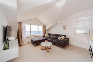 a living room with a couch and a table at Apartments Separovic in Prizba