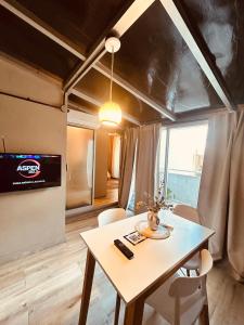 a dining room with a table and a tv at Rent Montañeses Nuñez in Buenos Aires