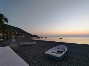 a boat sitting on the shore of a beach at B&B T'Amo in Lipari