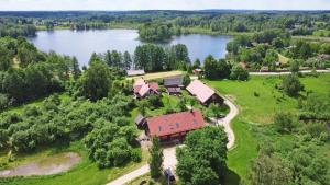 an aerial view of a house on the shore of a lake at Sunny Beaver B&B in Trakai