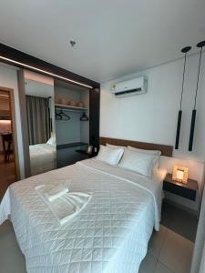 a bedroom with a large white bed in it at Salinas Beach Resort in Salinópolis +22 photos