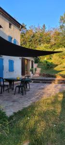 a patio with two benches and a building at Ecrin de Verdure in Anneyron +6 photos