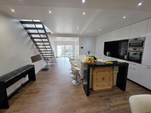 a kitchen with a counter and a staircase in a house at Home cinema in Liège