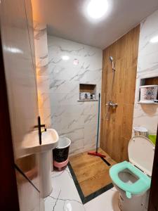 a bathroom with a toilet and a sink at Stoph in Beni Mellal +5 photos