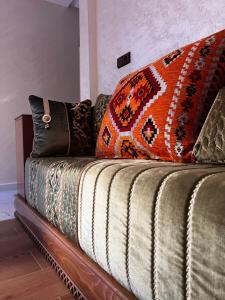 a couch with colorful pillows on top of it at Stoph in Beni Mellal