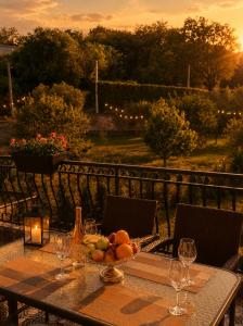 a table with a bowl of fruit and a candle at Maison Des Oliviers in Herceg-Novi