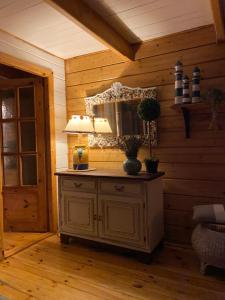 a room with a table with a lamp and a mirror at Sunny House Baltic in Kopalino
