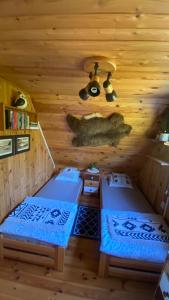 a room with two beds in a log cabin at Sunny House Baltic in Kopalino