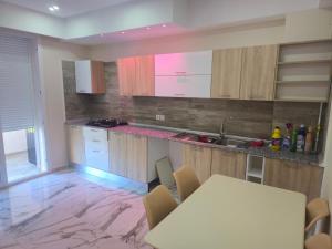 a kitchen with a table and a counter top at Apparemment valmascort annaba in Annaba