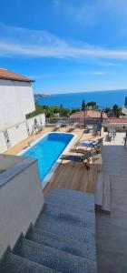 a view of a swimming pool with chairs and a building at Vila Eden in Bar