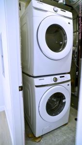 a washer and dryer stacked on top of each other at The Ivory house in Prince George