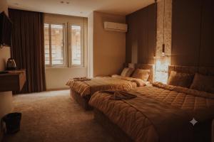 a hotel room with two beds and a window at Sydney DownTown-Cairo in Cairo