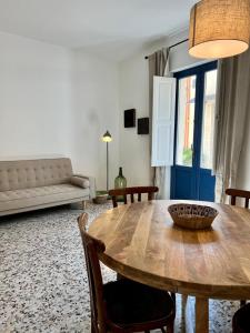 a living room with a wooden table and a couch at Casa Fioraliso in Noto +7 photos
