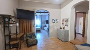 a living room with an archway and a room with a chair at Montefiori Luxury Suite & Spa in Bologna