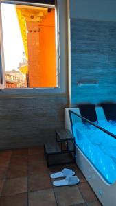 a swimming pool in a room with a window at Montefiori Luxury Suite & Spa in Bologna